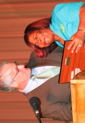 Woman on stage receiving award