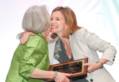 Woman on stage receiving award