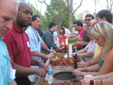 Group of people at picnic around table.