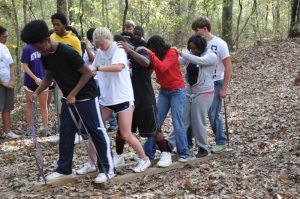 Children walking in a line in the woods.