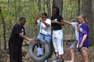 Children playing on tire swing.